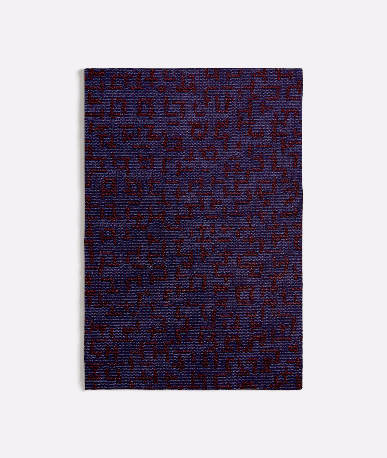 Deep blue-purple woven swatch with burgundy irregular geometric marks and subtle horizontal texture