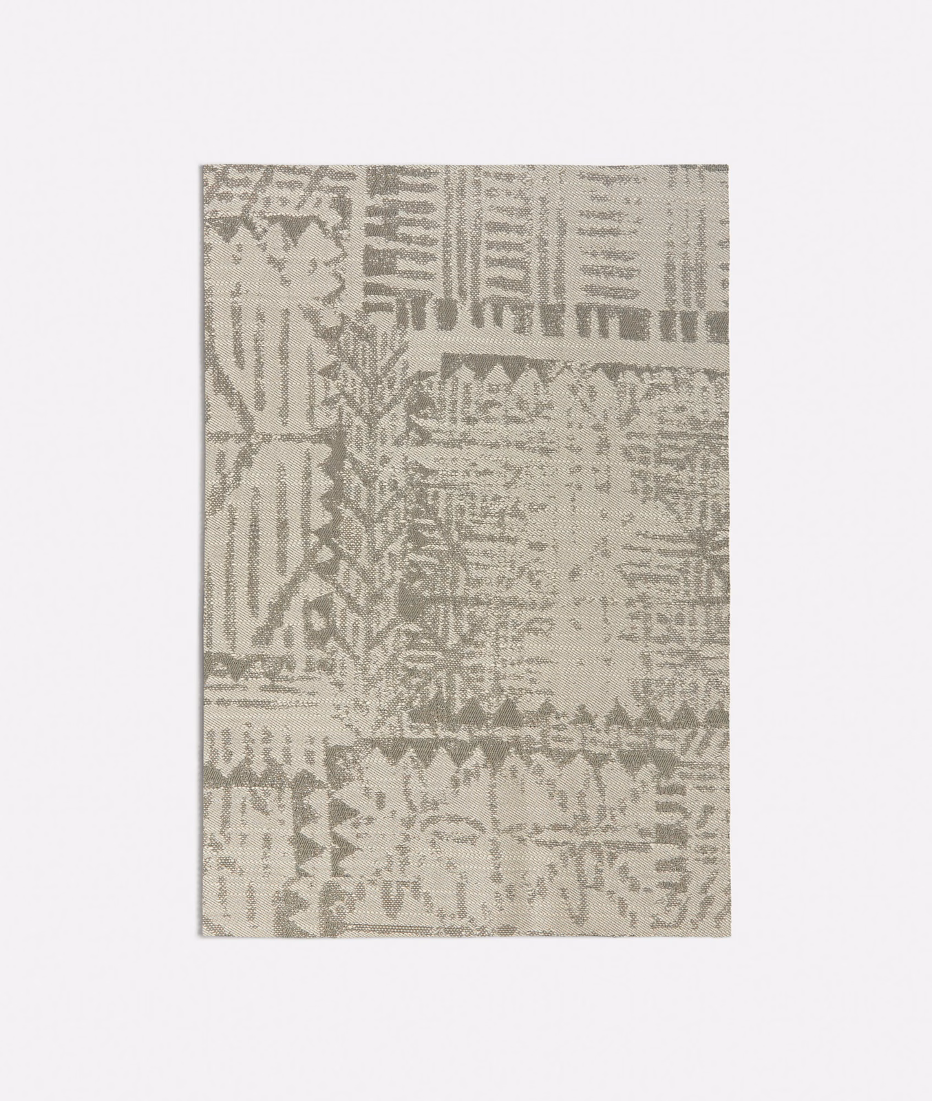 Warm grey-beige woven swatch with distressed patchwork, zigzags and linear motifs