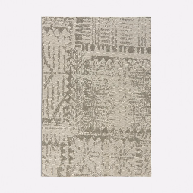 Warm grey-beige woven swatch with distressed patchwork, zigzags and linear motifs