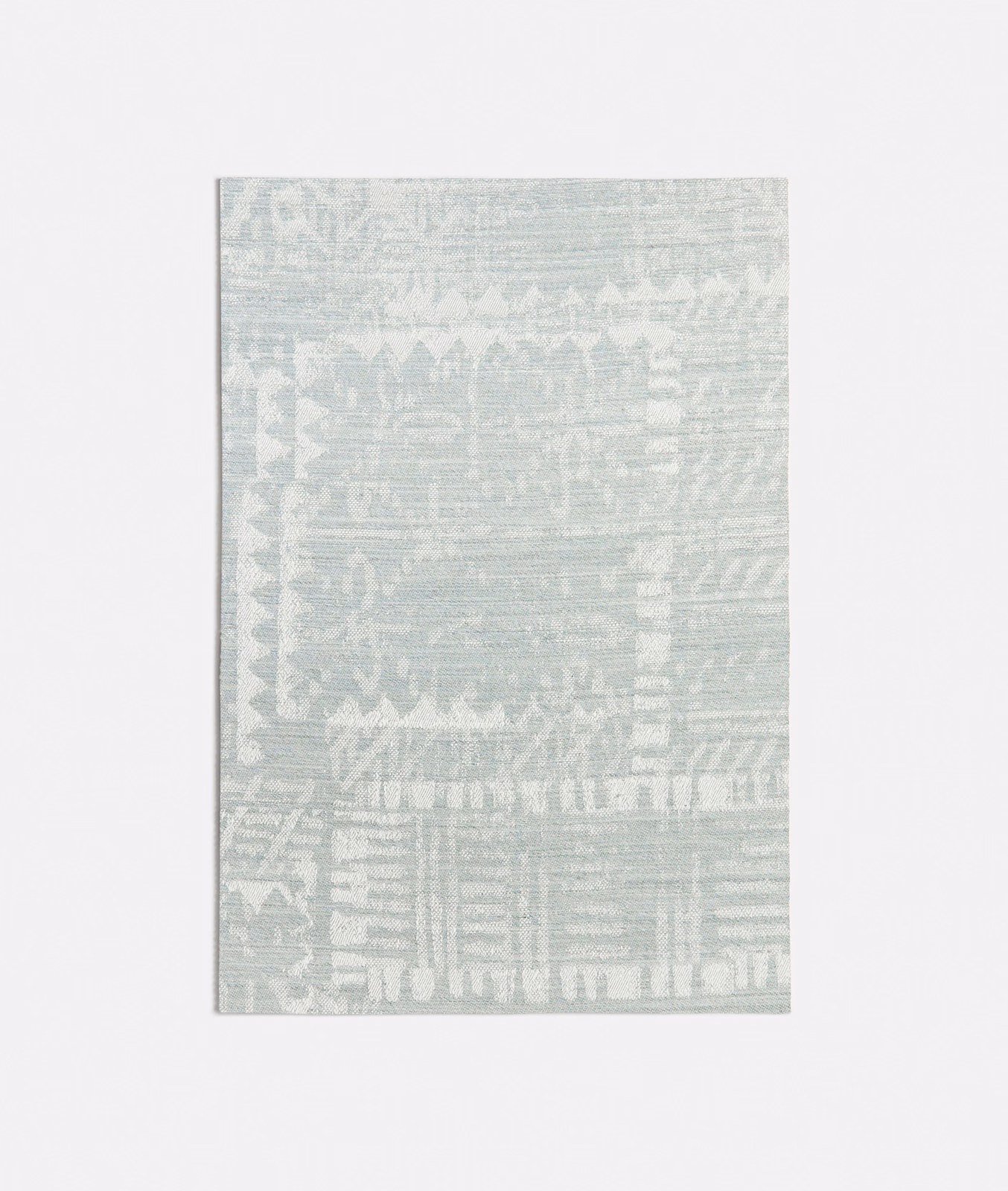 Pale seafoam textile with distressed geometric bands and softly striated woven texture