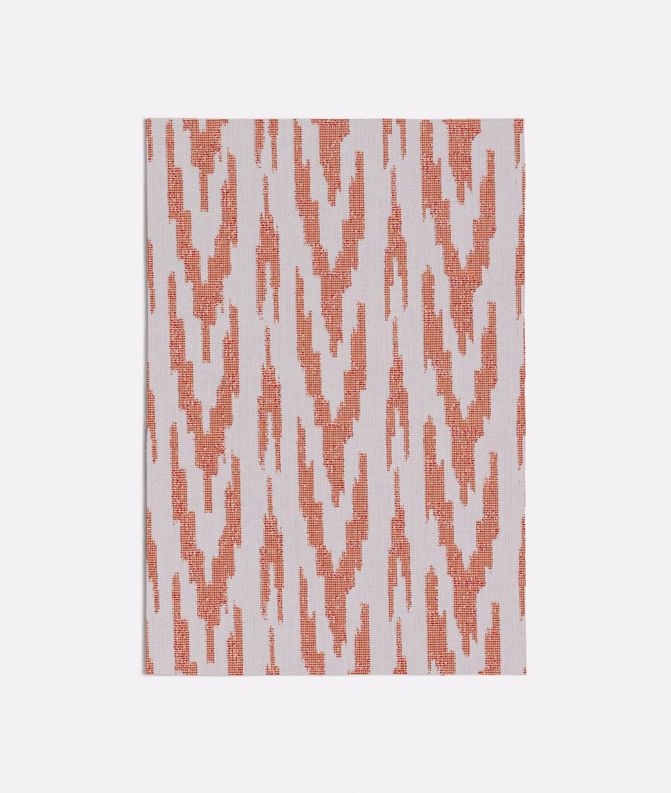 Muted coral-peach ikat motifs on a pale textured woven fabric ground