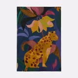 Deep blue woven swatch with a spotted giraffe and jewel-toned botanical motifs
