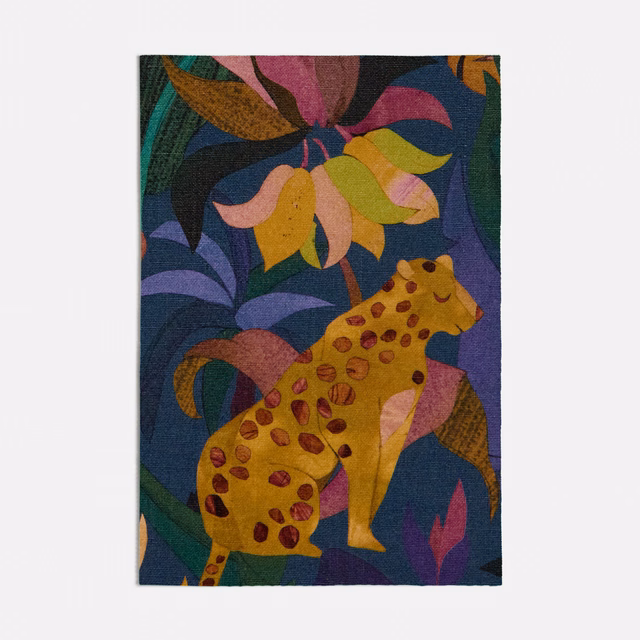 Deep blue woven swatch with a spotted giraffe and jewel-toned botanical motifs