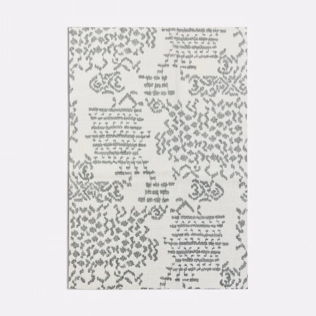 Pale seafoam fabric with grey script-like marks and distressed ornamental clusters