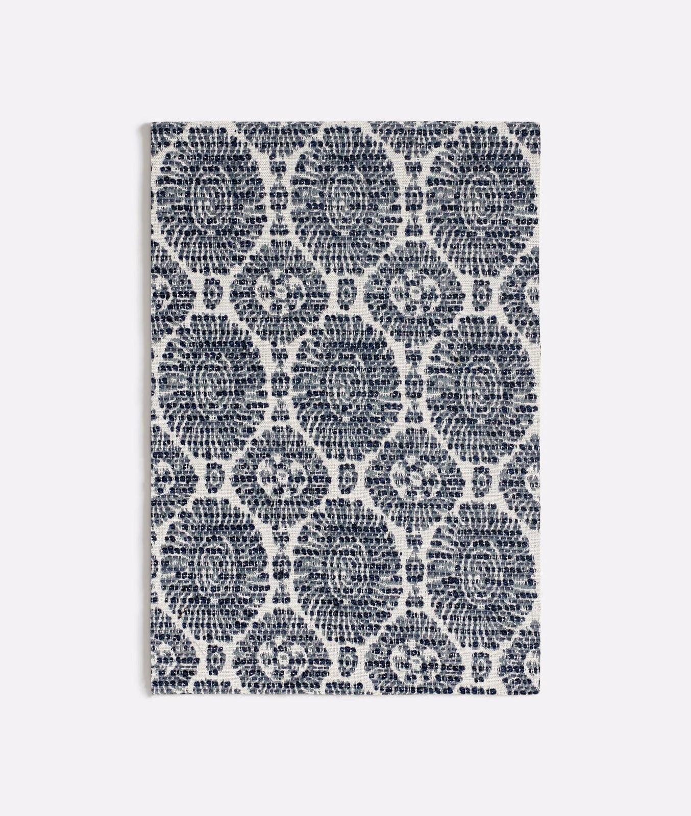 Textured blue fabric with navy floral medallions and pale blue ground