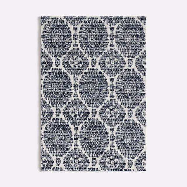 Textured blue fabric with navy floral medallions and pale blue ground