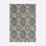 Muted seafoam fabric with charcoal floral medallions in a textured repeating weave