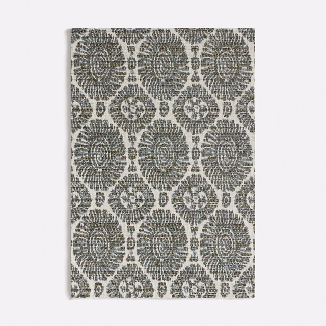 Muted seafoam fabric with charcoal floral medallions in a textured repeating weave