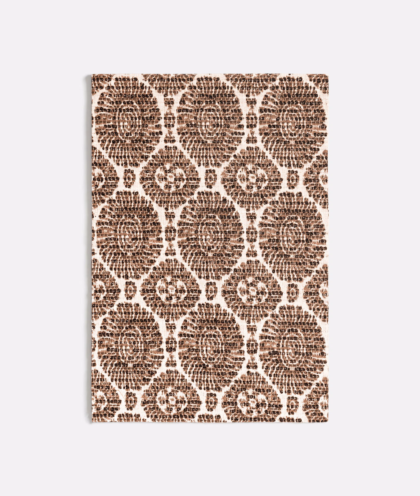 Warm cocoa medallions and rosettes on an ivory textured fabric swatch