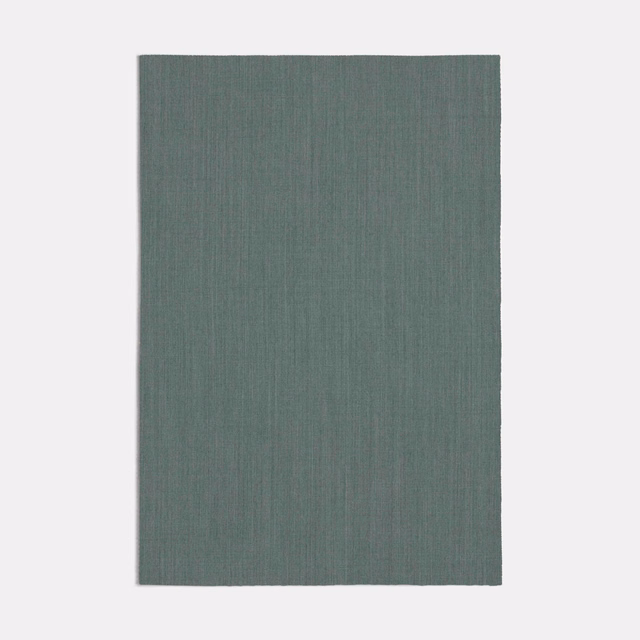 Muted seafoam-teal textile swatch with fine, shadowed vertical striations