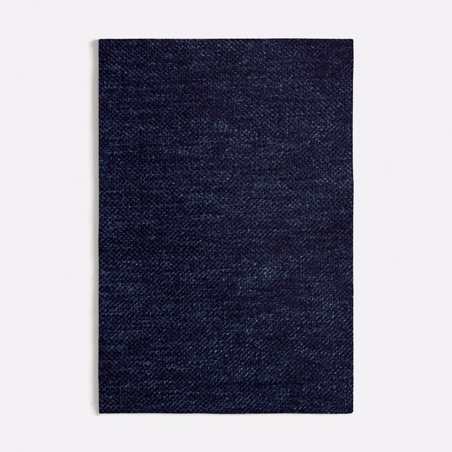Close view of Lucrezia Blue’s dark navy mottled weave with fine blue variation