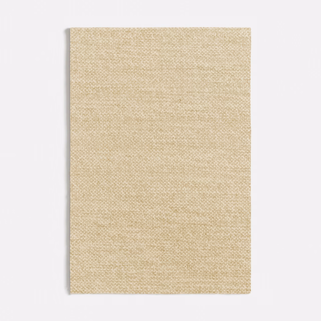 Warm oatmeal-beige fabric with a fine, softly flecked woven surface