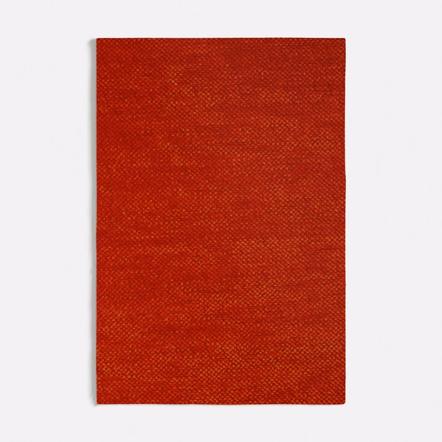 Rectangular swatch of deep burnt-orange woven fabric with fine crosshatch texture and tonal bands