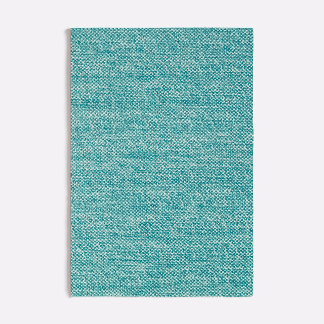 Close-up of cool turquoise woven fabric with fine aqua flecks and subtle horizontal texture