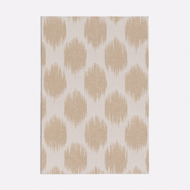 Warm oat beige and ivory textile with irregular brushed ikat-style motifs