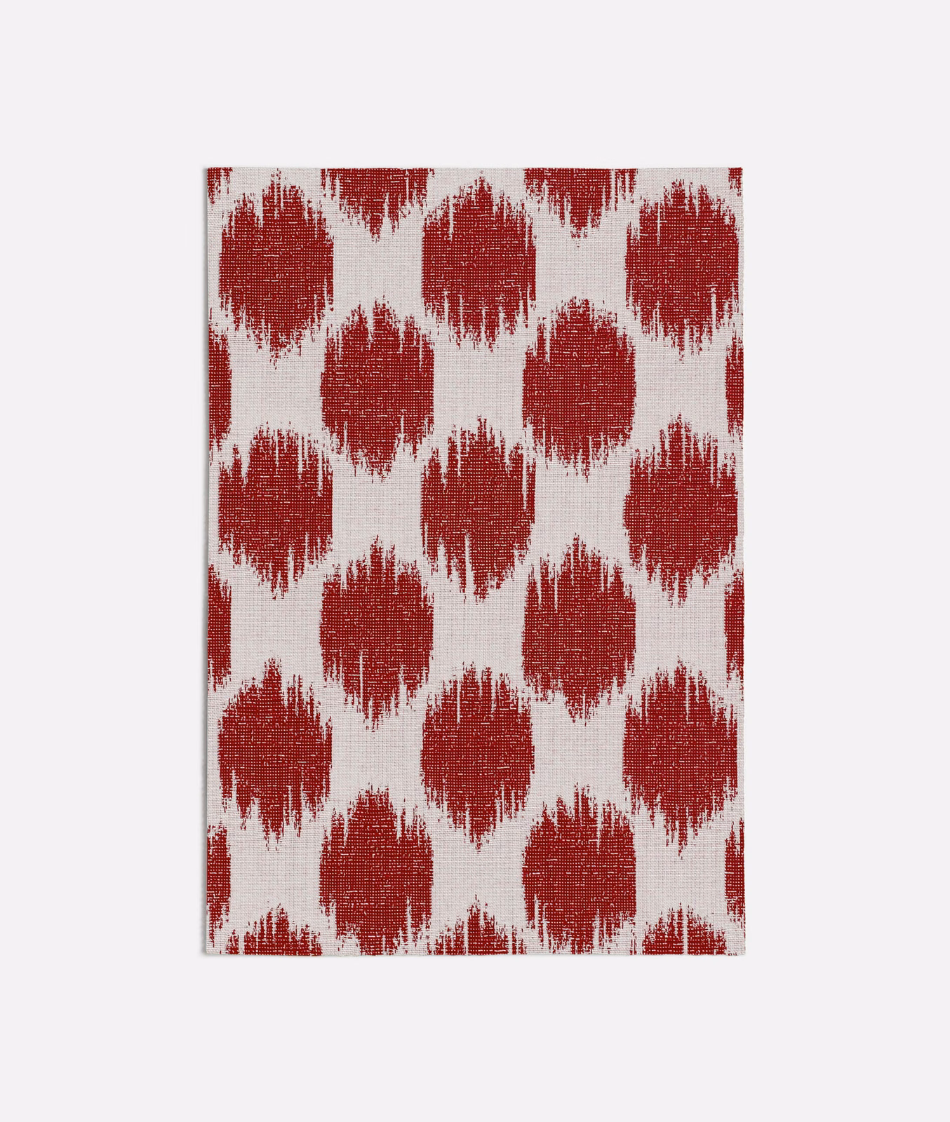 Deep red brush-edged ikat-style motifs woven across an ivory ground