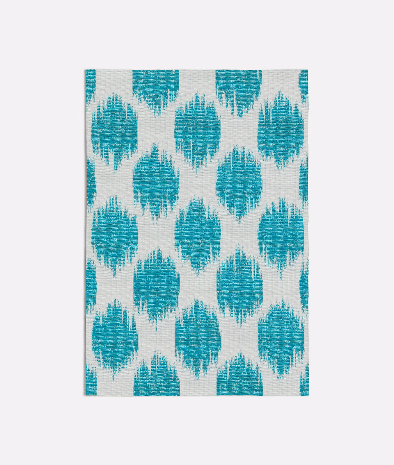 Turquoise and ivory ikat diamonds with a softly brushed woven texture
