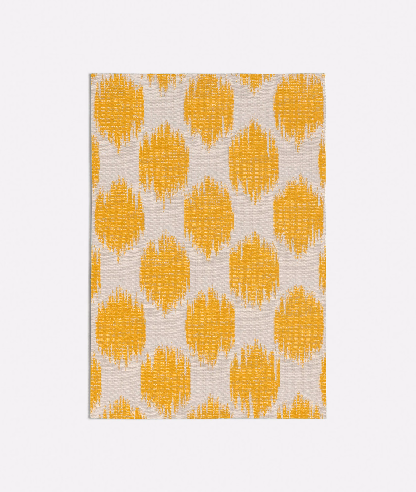 Saffron-yellow ikat-style motifs on a textured ivory woven ground