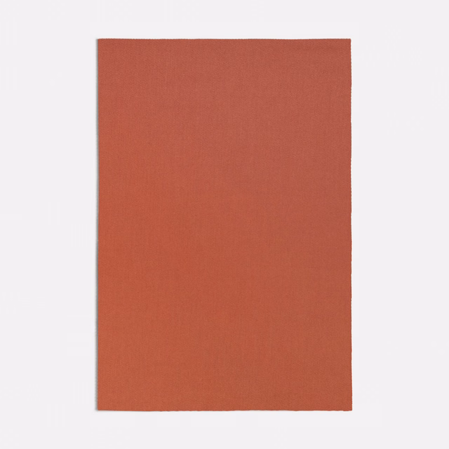 Warm terracotta plain-weave swatch with a fine, subtly vertical surface texture