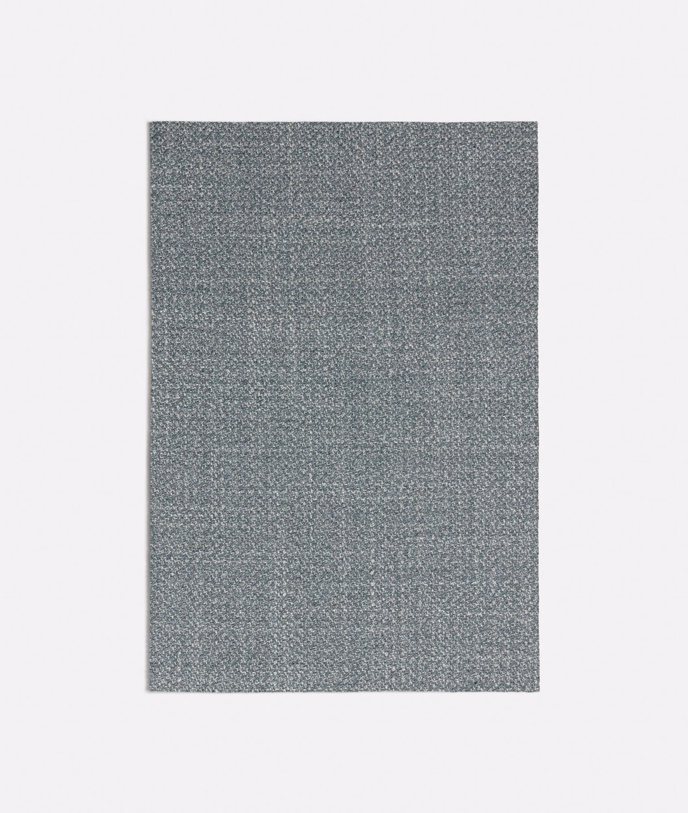 Close-up of muted seafoam-grey woven fabric with a fine mottled texture