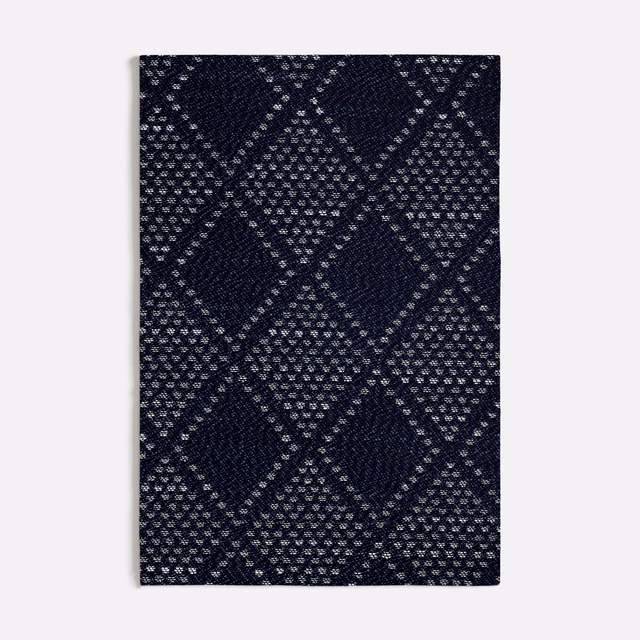 Deep navy woven fabric with pale flecked interlocking diamond bands