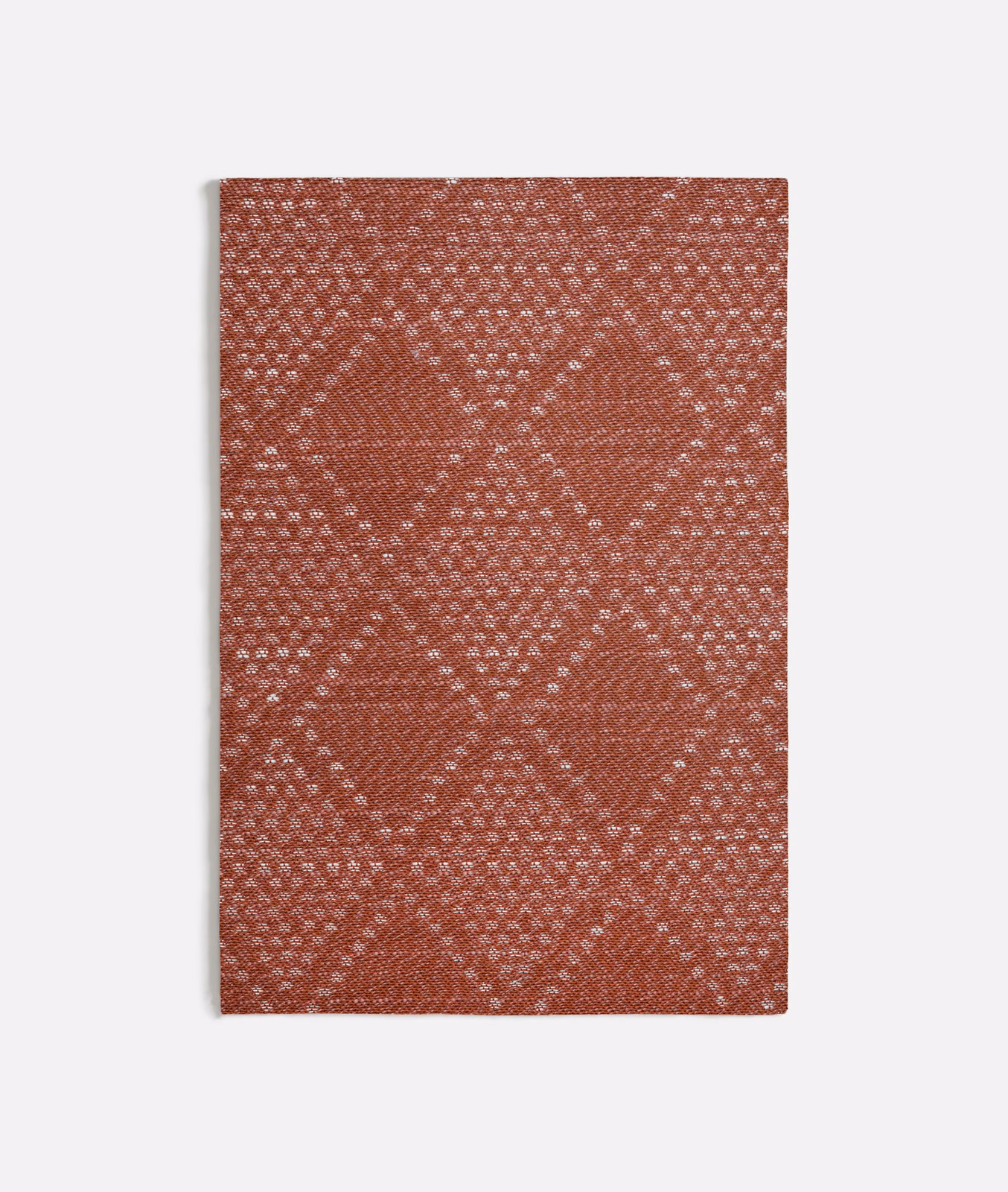 Rust terracotta woven swatch with pale flecked diamond lattice and tactile texture