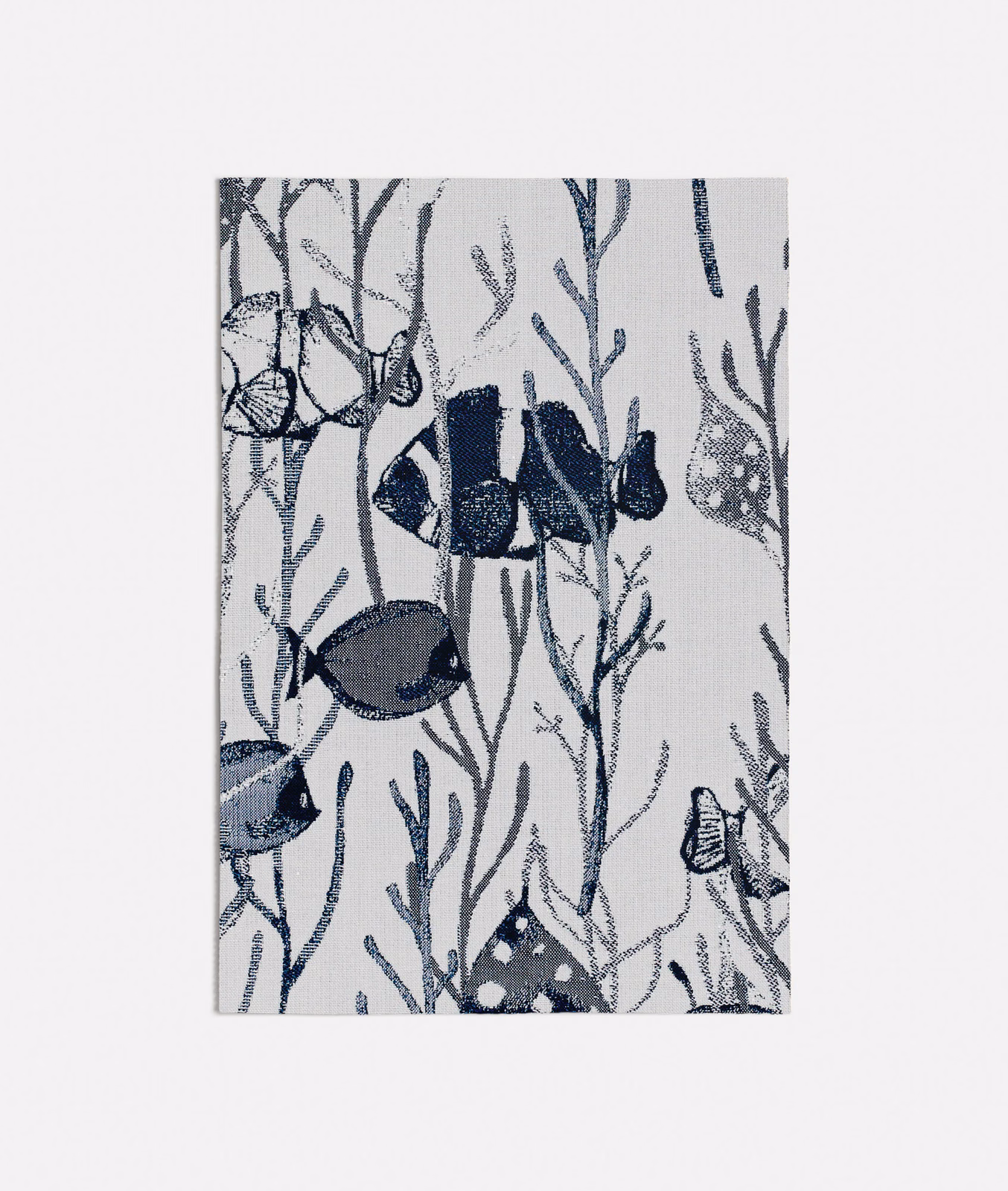 Ivory-grey textile with navy fish, branching seaweed and fine woven texture