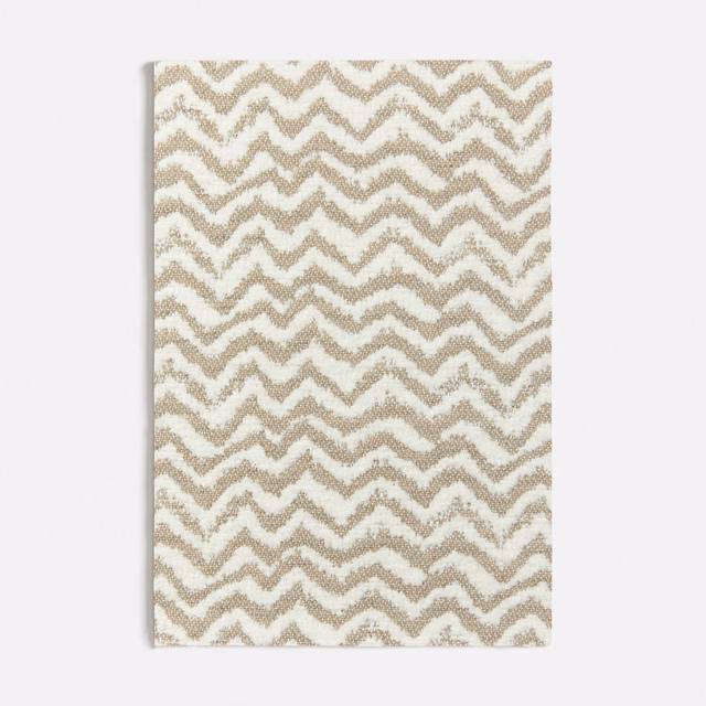 Warm beige and cream woven textile with irregular zigzag chevron bands