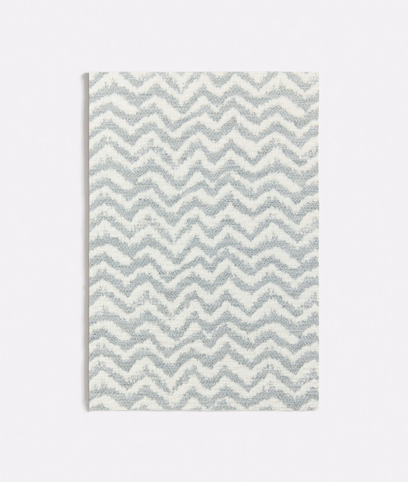 Pale seafoam and ivory woven fabric with a compact, tactile zigzag pattern