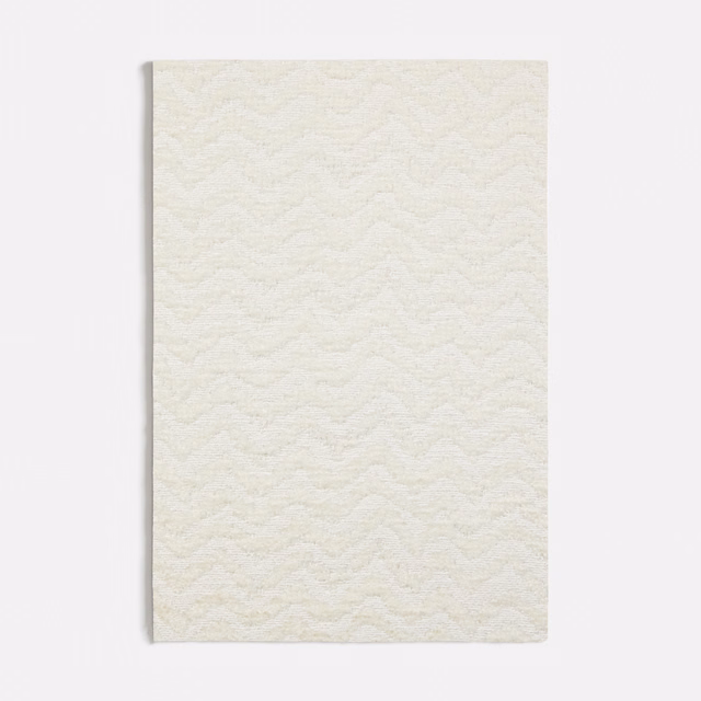 Ivory white fabric with a softly raised, repeating wave texture