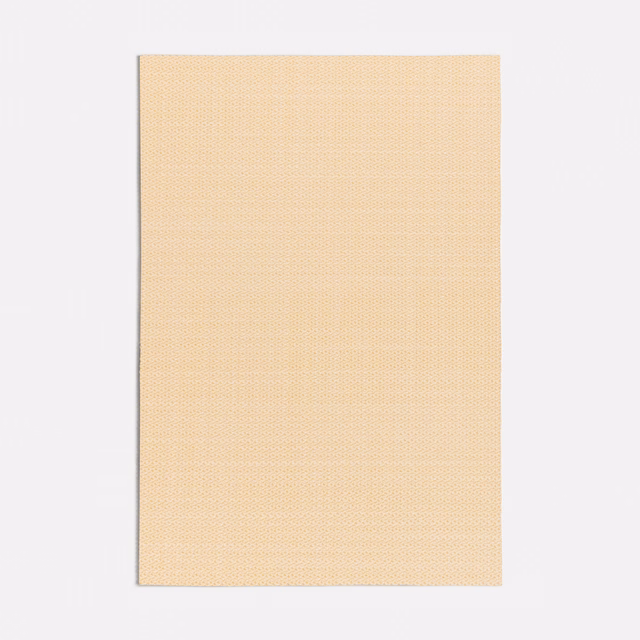 Close view of pale papaya-yellow fabric with a fine, even woven surface