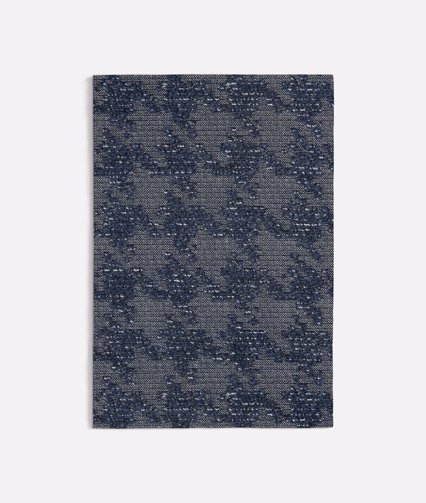 Blue-grey pied-de-poule weave with navy flecks and a tactile textured surface