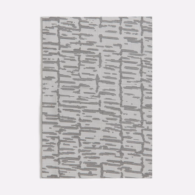 Pale grey textile with broken black-grey horizontal lines and tactile woven texture