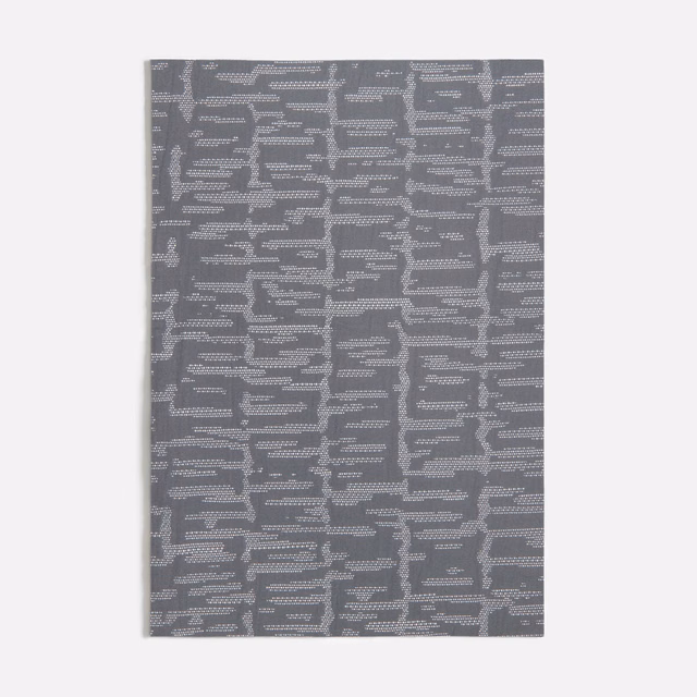 Dark grey woven swatch with a pale broken geometric line motif