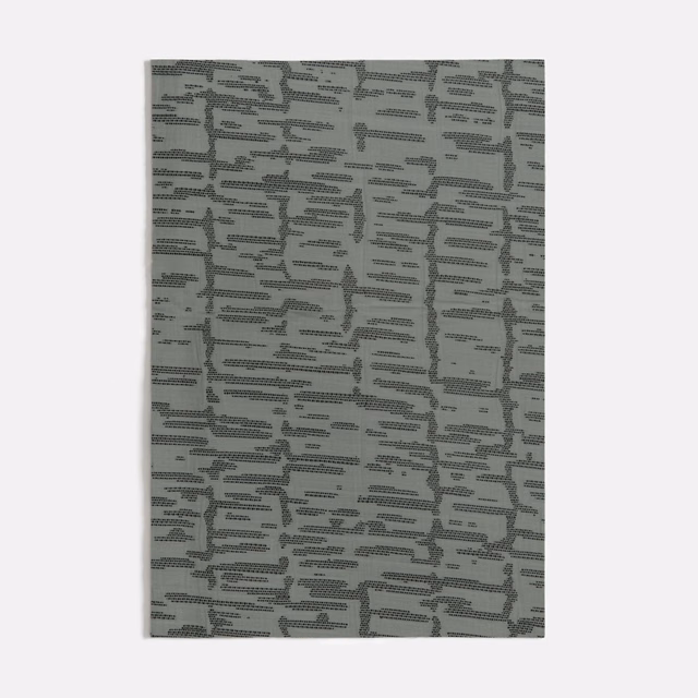 Muted seafoam textile with charcoal-grey broken maze-like woven lines