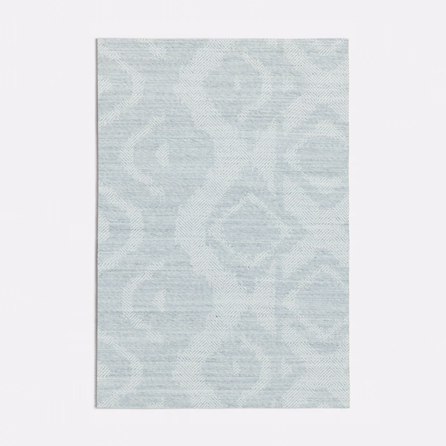 Pale seafoam woven textile with large low-contrast scrolling motifs and fine horizontal texture