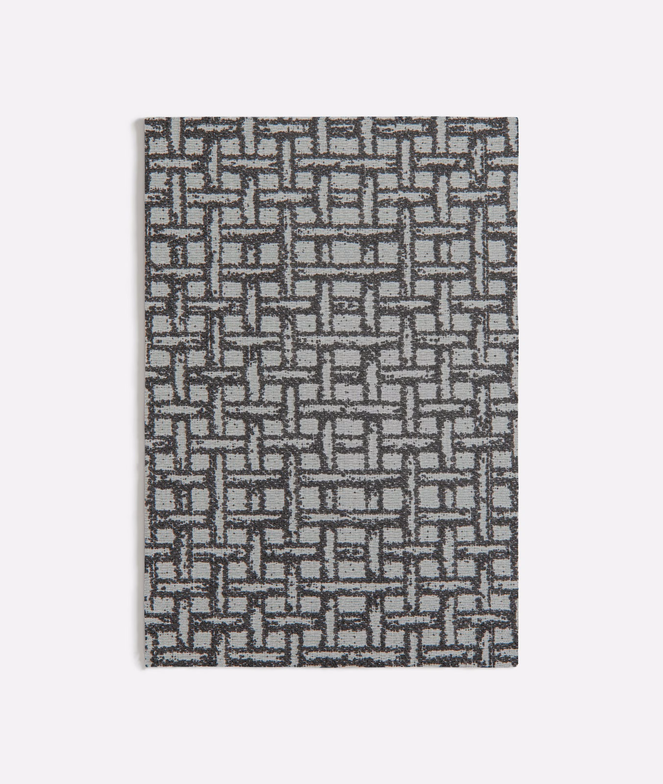 Charcoal and grey woven fabric with an interlocking rectangular maze motif