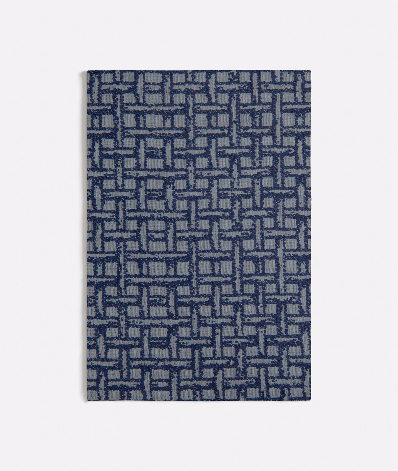 Blue-grey woven swatch with navy interlocking rectangles and subtly raised texture