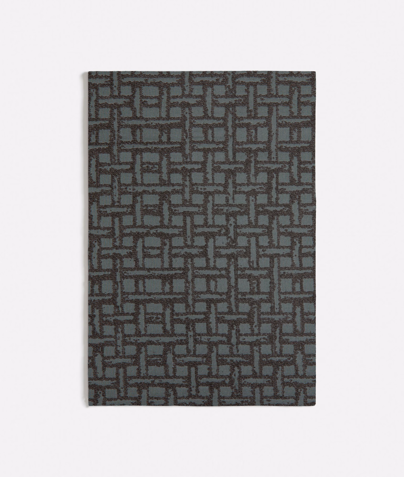 Muted rattan green textile with charcoal interlocking rectangular geometric weave