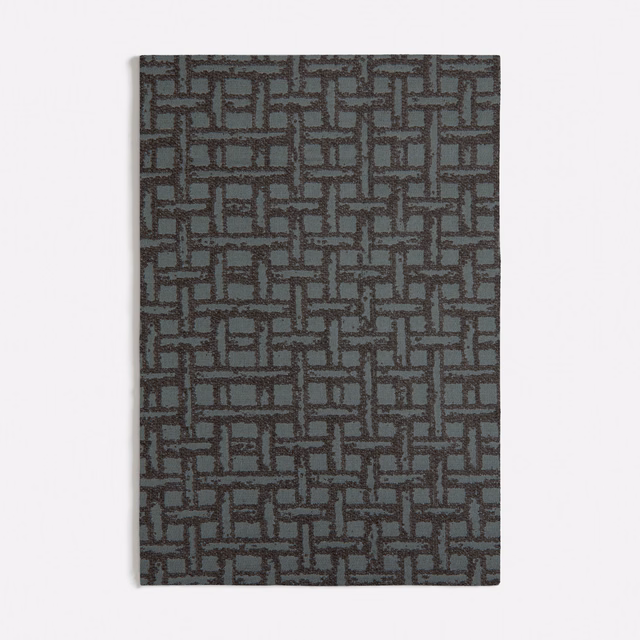 Muted rattan green textile with charcoal interlocking rectangular geometric weave