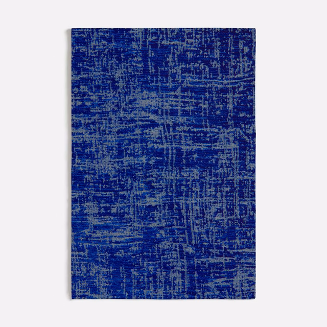 Deep cobalt blue textile with irregular blue-grey crosshatched woven texture