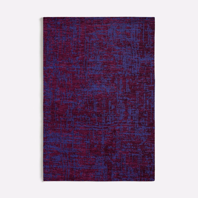 Deep purple textile with blue and burgundy threads in a distressed abstract grid weave