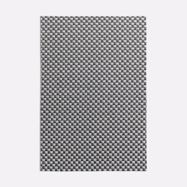 Close view of a charcoal and mid-grey micro-check woven textile