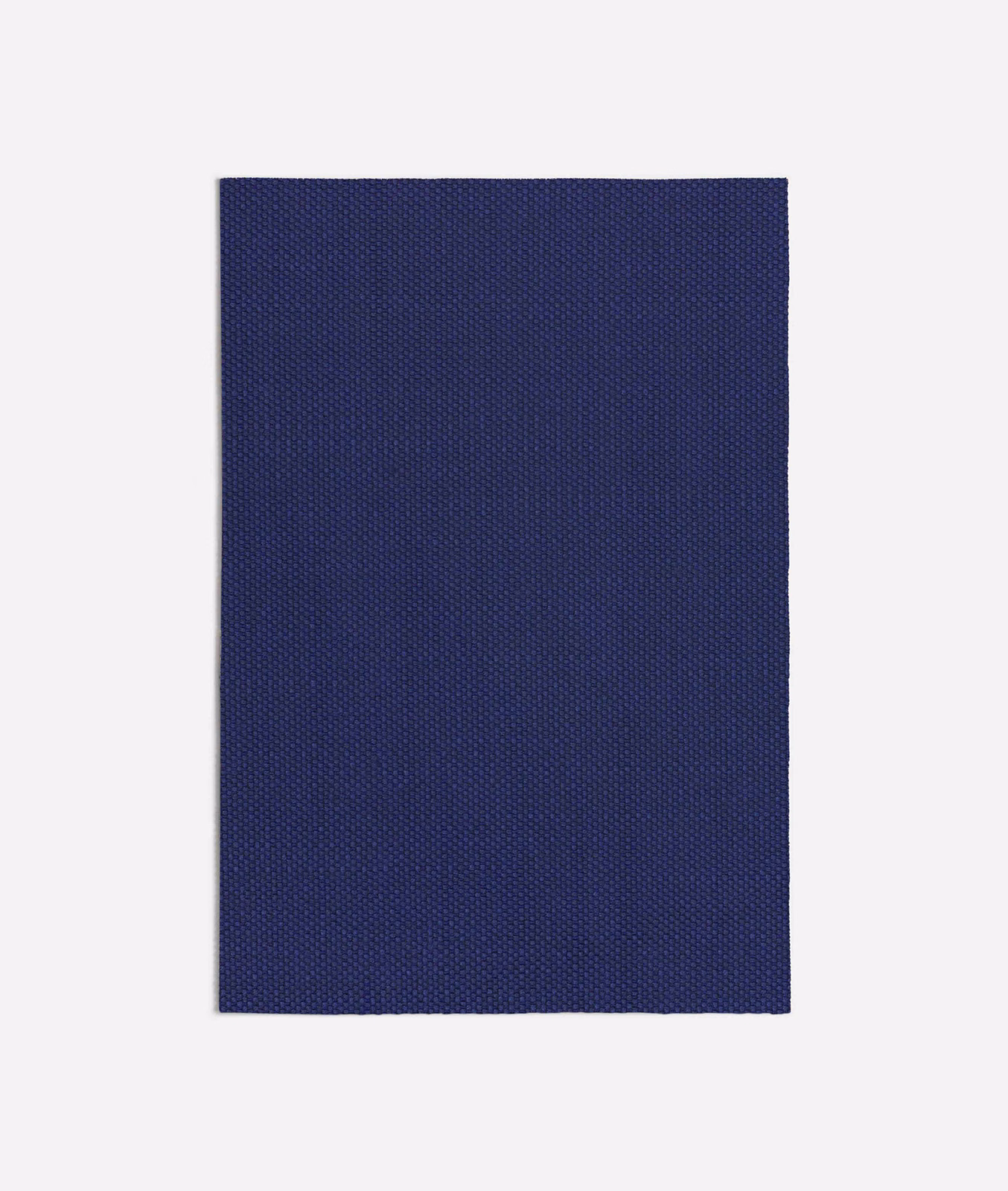 Deep indigo-blue fabric swatch with a fine, densely woven pinpoint texture