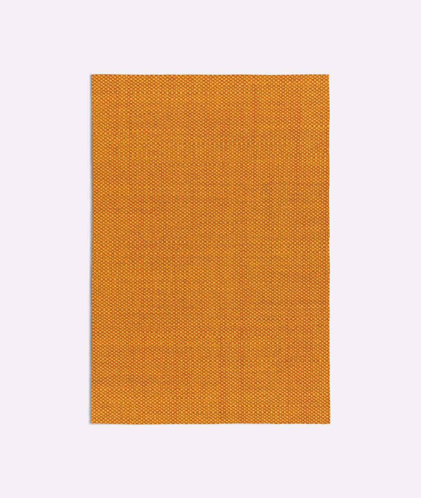 Warm burnt orange fabric with a dense tiny check weave and subtle golden tonal variation