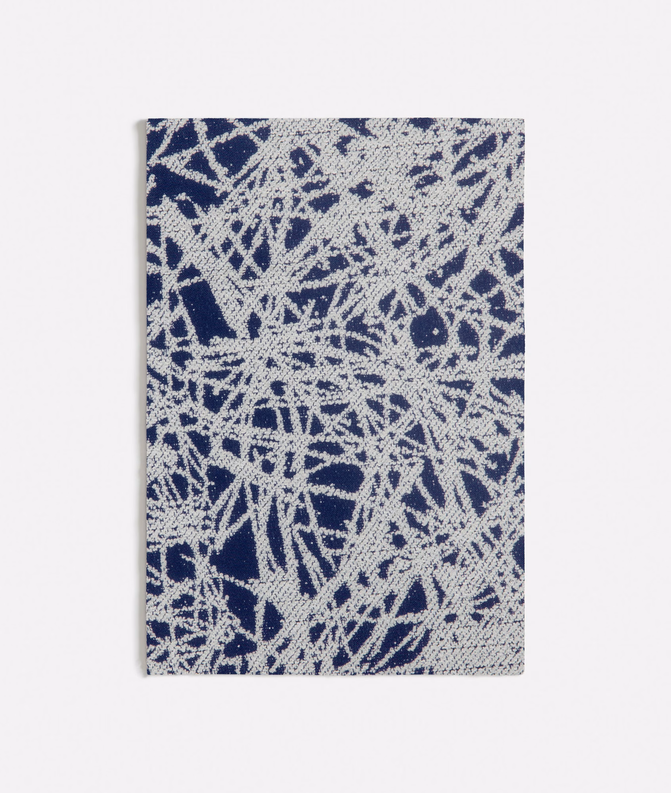 Deep blue woven ground with dense ivory scratch-like abstract marks