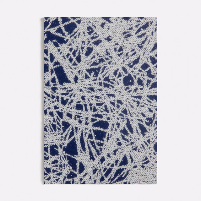 Deep blue woven ground with dense ivory scratch-like abstract marks