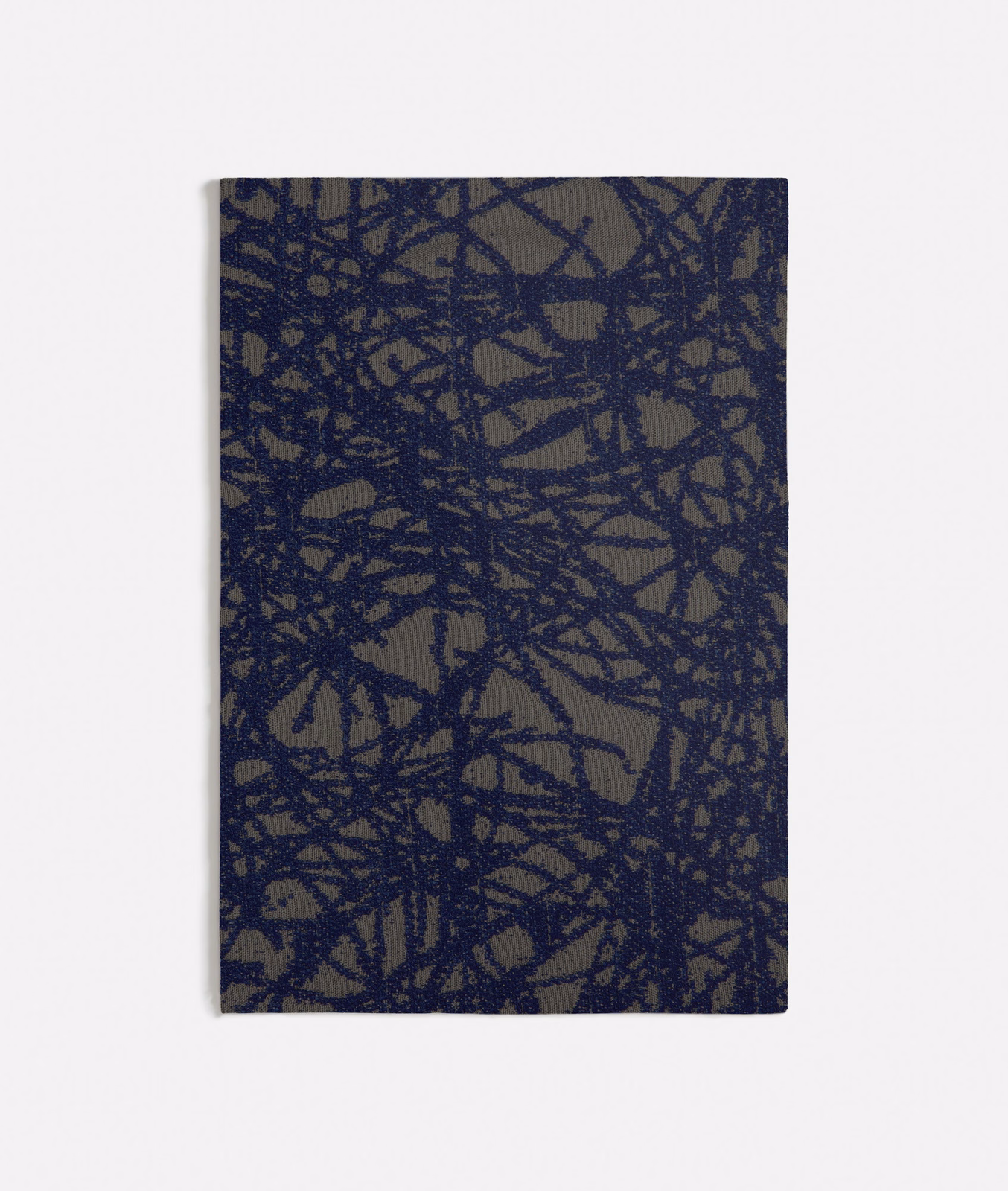 Deep navy scribble lines over a muted taupe, textured woven ground