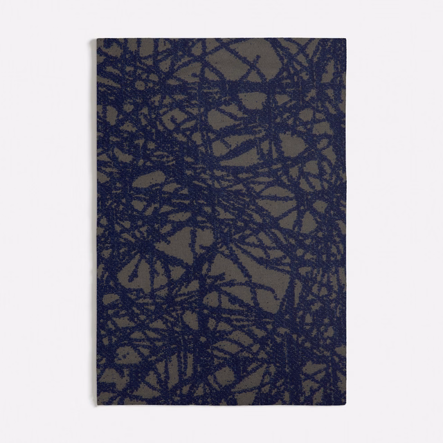 Deep navy scribble lines over a muted taupe, textured woven ground