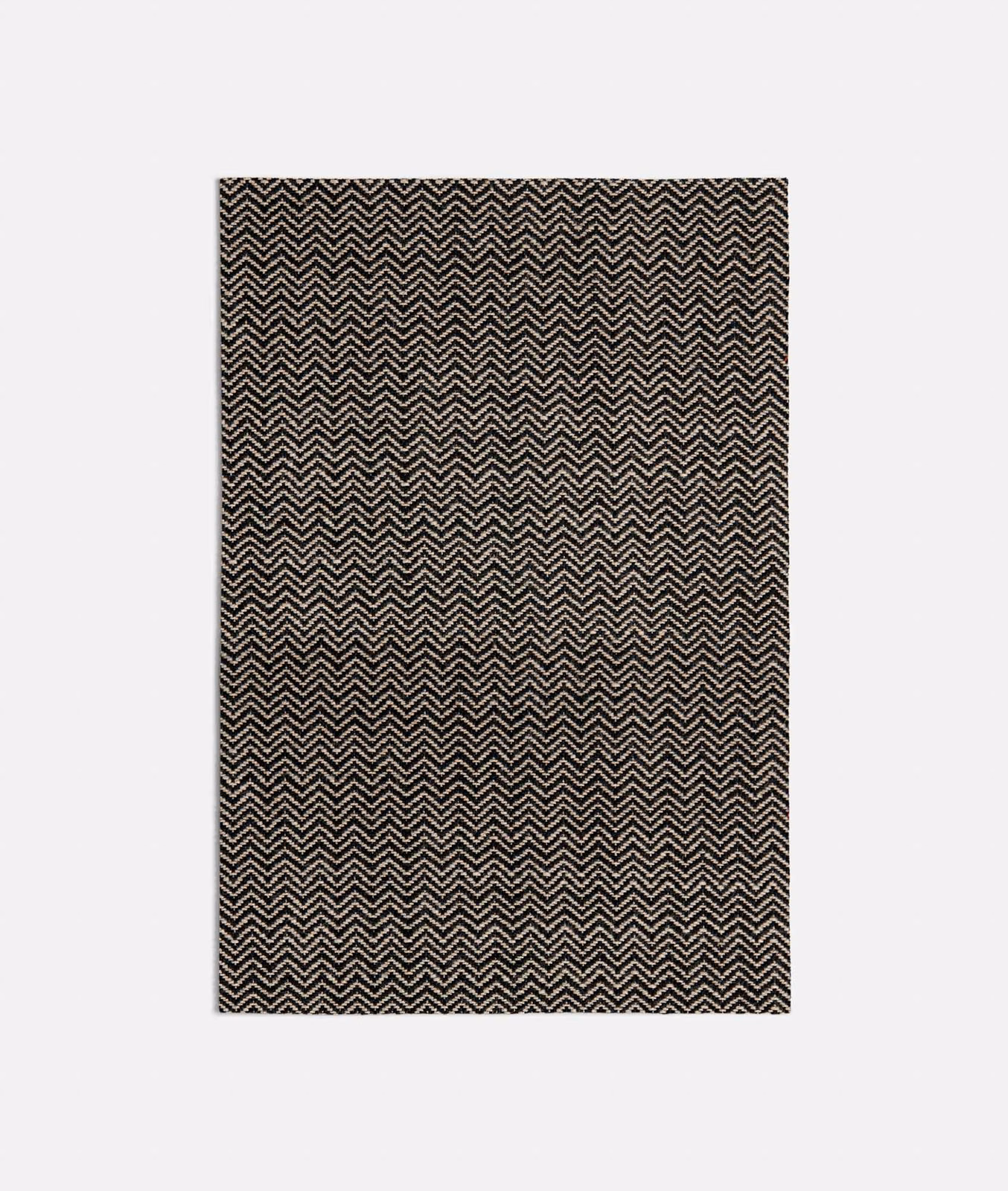 Fine ivory chevrons woven across a textured near-black Spiga Black fabric swatch
